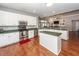 Bright open kitchen featuring stainless steel appliances, white cabinets, and island with green countertop at 1433 Oakhurst Dr, Mount Pleasant, SC 29466