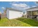 Backyard featuring a grassy area, white storage shed, and screened-in porch with outdoor seating at 1586 Innkeeper Ln, Johns Island, SC 29455
