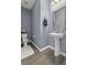 Charming half bathroom with textured wallpaper, pedestal sink, and elegant decor elements at 1586 Innkeeper Ln, Johns Island, SC 29455