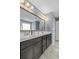 Bathroom featuring a double vanity with white counters, and a shower with glass doors at 1586 Innkeeper Ln, Johns Island, SC 29455
