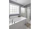 Modern bathroom featuring a soaking tub and a glass-enclosed shower at 1586 Innkeeper Ln, Johns Island, SC 29455