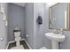 Stylish half bathroom features attractive wallpaper, modern fixtures, and decor at 1586 Innkeeper Ln, Johns Island, SC 29455