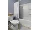 Bathroom with white tub and shower combination with sliding door and gray striped shower curtain at 1586 Innkeeper Ln, Johns Island, SC 29455