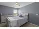Bedroom featuring neutral decor, a ceiling fan, and a wooden dresser with a decorative table lamp at 1586 Innkeeper Ln, Johns Island, SC 29455