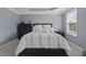 Comfortable bedroom featuring a tray ceiling, a window, and a black dresser and nightstands at 1586 Innkeeper Ln, Johns Island, SC 29455