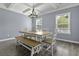 Bright dining room offers a modern chandelier, coffered ceiling, and a wooden table with bench seating at 1586 Innkeeper Ln, Johns Island, SC 29455