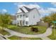 Charming two-story home with a front porch, well-manicured lawn, and mature trees at 1586 Innkeeper Ln, Johns Island, SC 29455