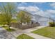 Charming home exterior with fenced backyard, detached garage, and lush lawn at 1586 Innkeeper Ln, Johns Island, SC 29455