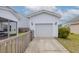 View of detached garage with concrete driveway and tasteful landscaping at 1586 Innkeeper Ln, Johns Island, SC 29455
