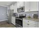 Modern kitchen featuring stainless steel appliances, granite countertops, and ample cabinet space at 1586 Innkeeper Ln, Johns Island, SC 29455