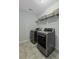 Laundry room with stainless steel front load washer and dryer, and wire shelving at 1586 Innkeeper Ln, Johns Island, SC 29455