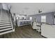 Spacious living room showcases stairs, wood floors, and an open layout with a breakfast bar at 1586 Innkeeper Ln, Johns Island, SC 29455