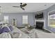 Cozy living room with a fireplace, plush seating, and a ceiling fan at 1586 Innkeeper Ln, Johns Island, SC 29455