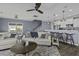 Cozy living room features a ceiling fan, comfortable seating, and an open layout connecting to the kitchen at 1586 Innkeeper Ln, Johns Island, SC 29455