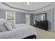 Comfortable primary bedroom exhibits a tray ceiling, carpeted floors, and a decorative mirror at 1586 Innkeeper Ln, Johns Island, SC 29455