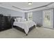 Serene primary bedroom with a tray ceiling, plush carpet, and plenty of natural light at 1586 Innkeeper Ln, Johns Island, SC 29455