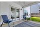 Cozy screened patio with outdoor seating, a small table and a view of the backyard at 1586 Innkeeper Ln, Johns Island, SC 29455