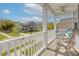 View from covered front porch with white railings, furniture, and a neighborhood view at 1586 Innkeeper Ln, Johns Island, SC 29455