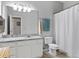 This is a bathroom with granite counters, a large mirror, white cabinets, a toilet, and a shower with a white curtain at 1600 Long Grove Dr # 1226, Mount Pleasant, SC 29464