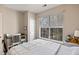 This is a cute bedroom with a large window, desk, and chair and is nicely staged at 1600 Long Grove Dr # 1226, Mount Pleasant, SC 29464
