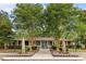 This is a full exterior view of the clubhouse, featuring a sidewalk, manicured landscaping, and palm trees at 1600 Long Grove Dr # 1226, Mount Pleasant, SC 29464