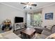Living room with a TV, a gray sofa, an area rug and sliding doors to a balcony at 1600 Long Grove Dr # 1226, Mount Pleasant, SC 29464