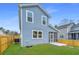 Backyard featuring a blue sided home, a lawn, and a wood fence at 1725 W Avalon Cir, Charleston, SC 29407
