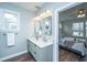 Bathroom with a double vanity, modern fixtures, and door to the bedroom at 1725 W Avalon Cir, Charleston, SC 29407