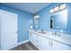 Bathroom with dual sinks, white cabinets, and modern fixtures at 1725 W Avalon Cir, Charleston, SC 29407