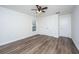 A bright bedroom featuring wood-look flooring, a ceiling fan, closet, and natural light from a window at 1725 W Avalon Cir, Charleston, SC 29407