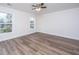 A bright bedroom featuring wood-look flooring, a ceiling fan, and natural light from windows at 1725 W Avalon Cir, Charleston, SC 29407