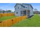 Charming two-story home with light blue siding, a fenced yard, and a screened-in porch for outdoor enjoyment at 1725 W Avalon Cir, Charleston, SC 29407