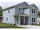 Charming two-story home with blue siding, white trim, and a welcoming front porch at 1725 W Avalon Cir, Charleston, SC 29407