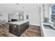 Spacious kitchen with an island, modern lighting, and an open layout connecting to other living spaces at 1725 W Avalon Cir, Charleston, SC 29407