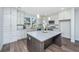 Modern kitchen featuring white cabinetry, stainless steel appliances, and a spacious island with seating at 1725 W Avalon Cir, Charleston, SC 29407