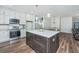 Modern kitchen featuring stainless steel appliances and an island, open to the dining and living areas at 1725 W Avalon Cir, Charleston, SC 29407