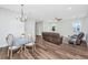 Open-concept living room and dining area with hardwood floors and modern furnishings at 1725 W Avalon Cir, Charleston, SC 29407