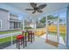 A screened porch includes a table, chairs, and a view of the backyard at 1725 W Avalon Cir, Charleston, SC 29407