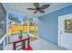 Screened in porch with blue wood siding, table, and view of the fenced in yard at 1725 W Avalon Cir, Charleston, SC 29407