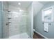 Tiled shower with glass door, shelving, and modern shower head at 1725 W Avalon Cir, Charleston, SC 29407