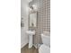 Stylish powder room with patterned tile accent wall at 1821 Mead Ln, Johns Island, SC 29455