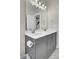 Modern bathroom featuring gray vanity, double sinks, and a large mirror with designer lighting at 1821 Mead Ln, Johns Island, SC 29455