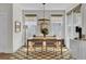 Bright dining room with a farmhouse-style table, modern chandelier, and a checkered floor at 1821 Mead Ln, Johns Island, SC 29455