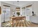 Cozy dining room featuring a wooden table, four chairs, natural light, and stylish decor at 1821 Mead Ln, Johns Island, SC 29455