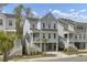Charming light blue stilt home featuring a covered porch, private garage, and a well-manicured lawn at 1821 Mead Ln, Johns Island, SC 29455