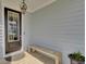 Charming front porch features a wooden bench, craftsman front door, and a lantern-style light fixture at 1821 Mead Ln, Johns Island, SC 29455