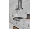 Modern kitchen featuring stainless steel range hood and white cabinets at 1821 Mead Ln, Johns Island, SC 29455