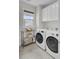 Well-equipped laundry room with modern washer, dryer, and plenty of storage at 1821 Mead Ln, Johns Island, SC 29455