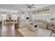 Bright living room features a comfortable white sectional sofa, large windows, and hardwood flooring at 1821 Mead Ln, Johns Island, SC 29455
