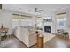 Cozy living room with a fireplace, a large sectional sofa, hardwood floors, and many windows at 1821 Mead Ln, Johns Island, SC 29455